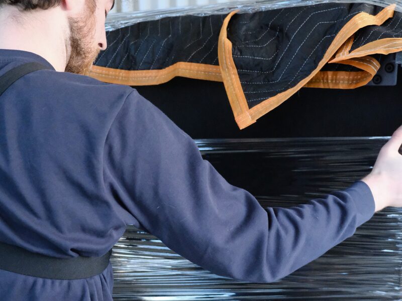 Crew wrapping furniture in moving blankets