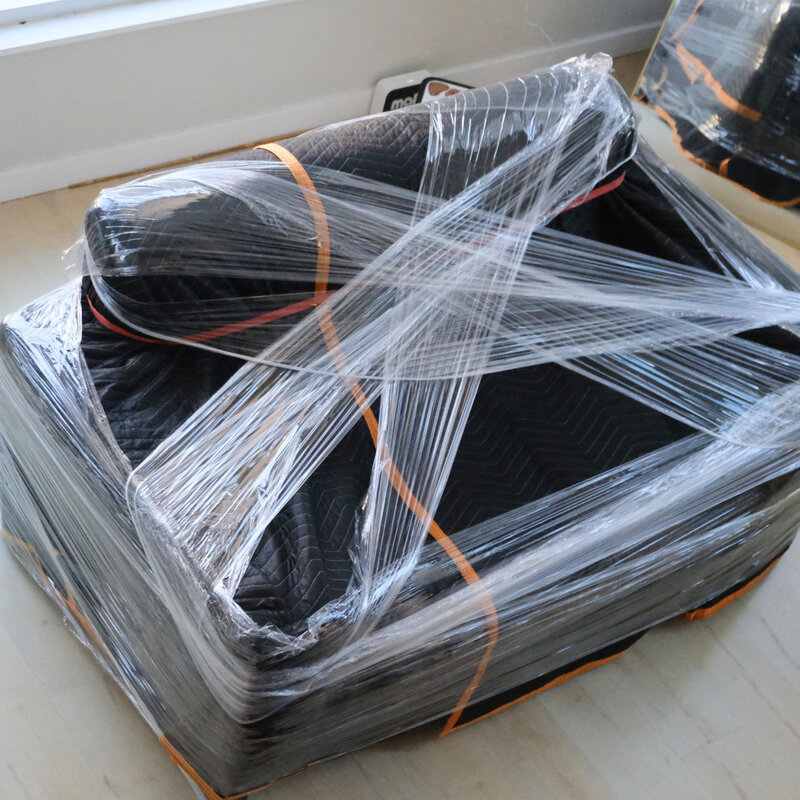 Chair fully wrapped in moving blankets and stretch wrap